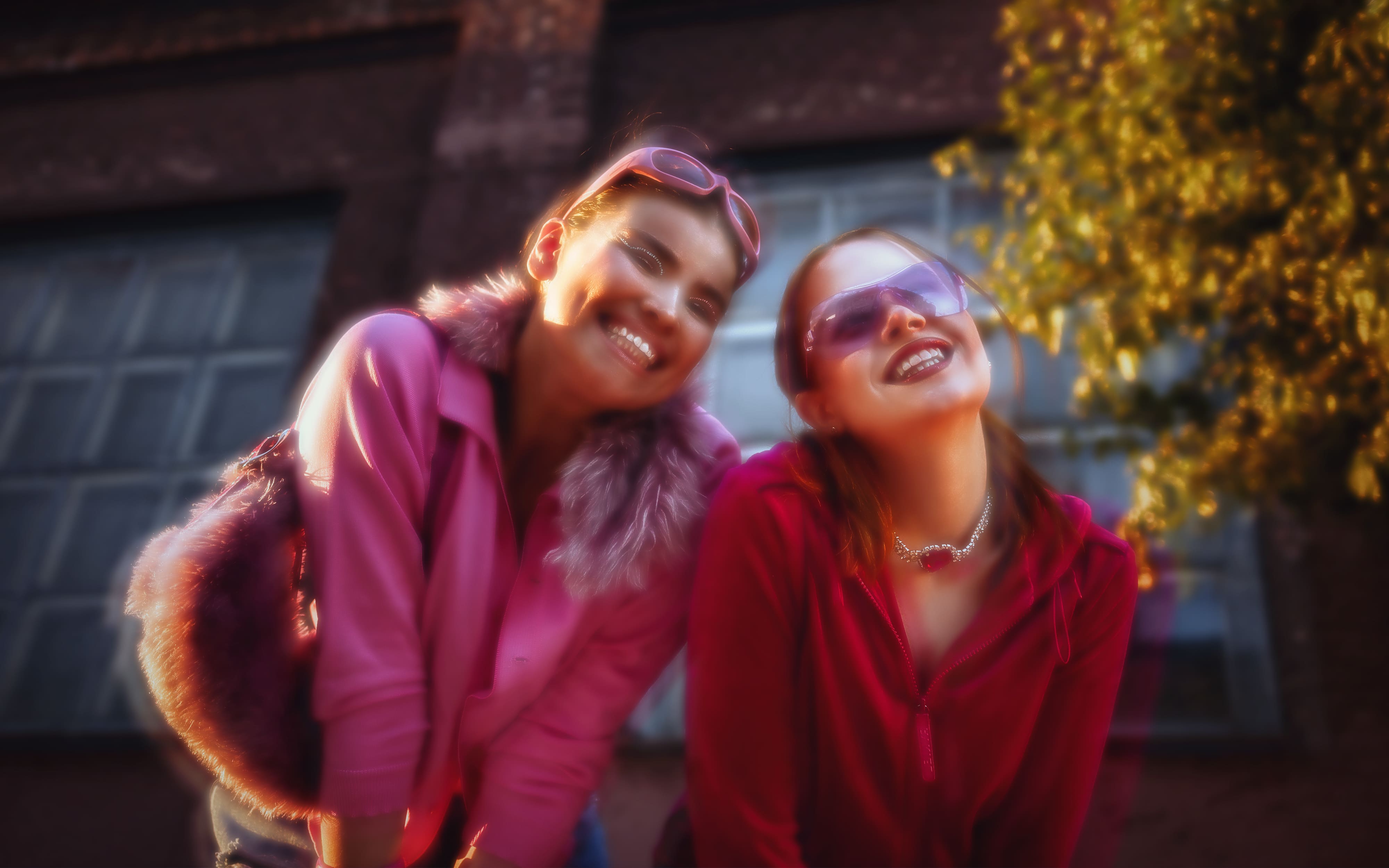 Two fashionable people in pink and red enjoying a bright moment together