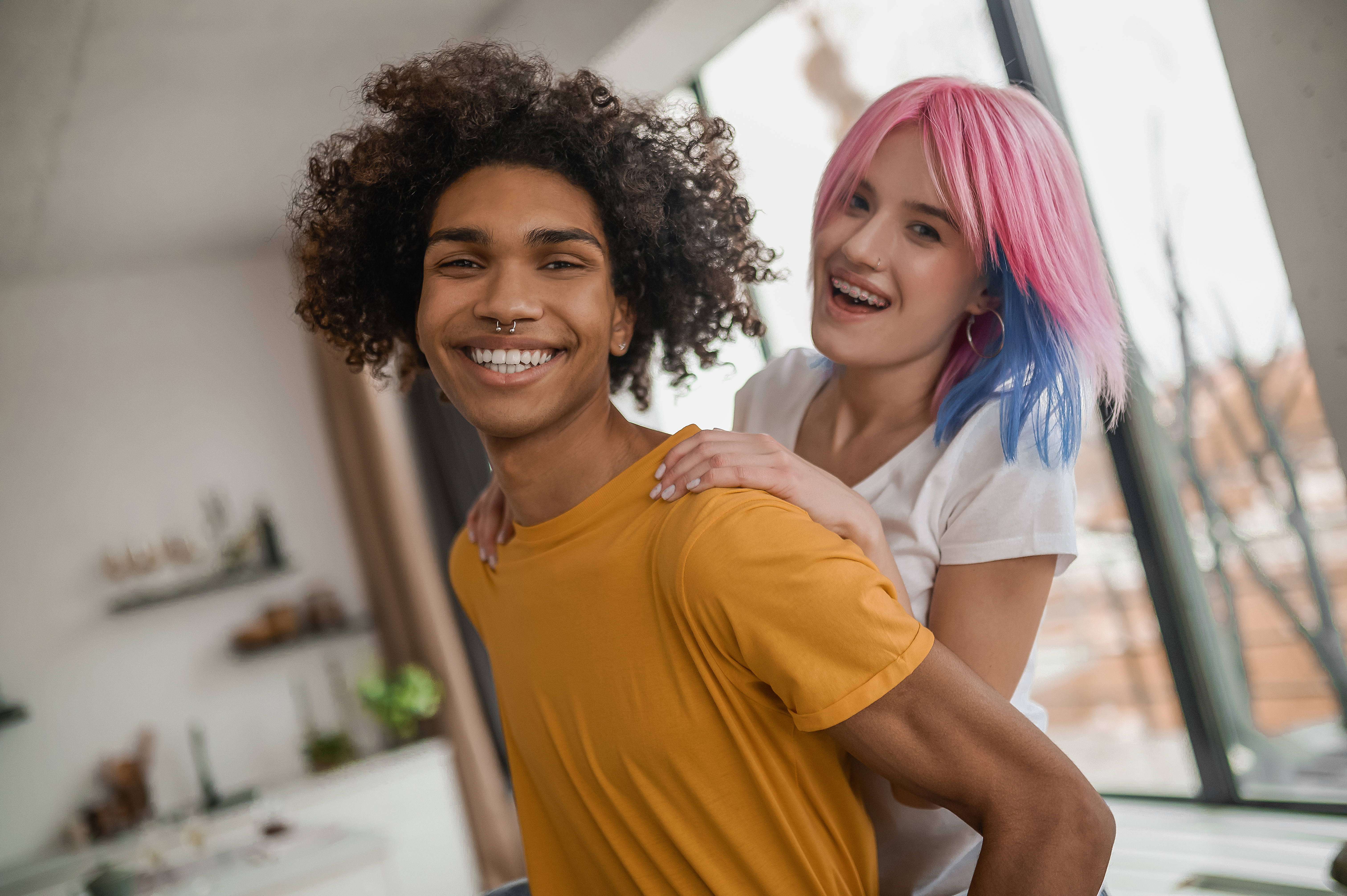 A young couple smiling together at home